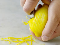 Photograph of zesting a lemon.