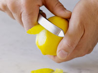 Photograph of peeling a lemon.